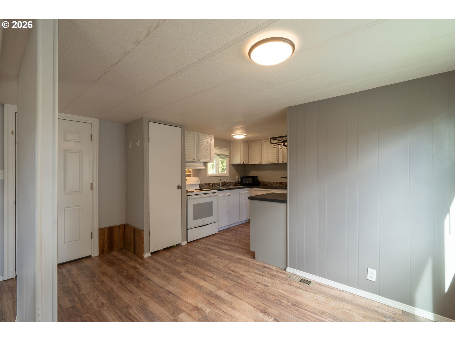2010 Southwest 3rd Street, Unit 16 Corvallis, OR 97333 - Photo 7 of 16 a kitchen with a refrigerator and window