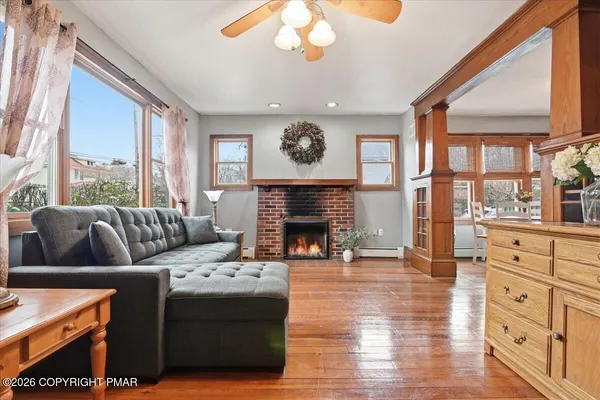 a living room with furniture and a wooden floor