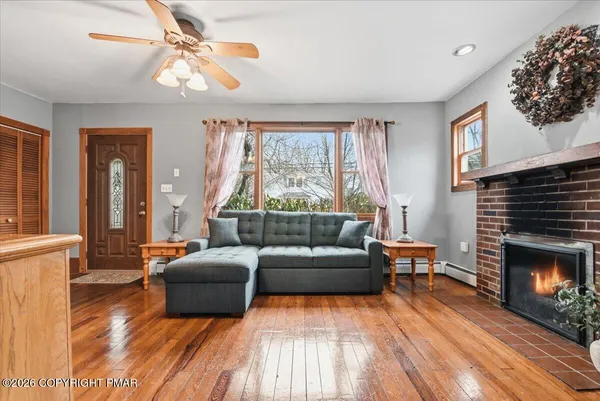 a view of a room with wooden floor and windows