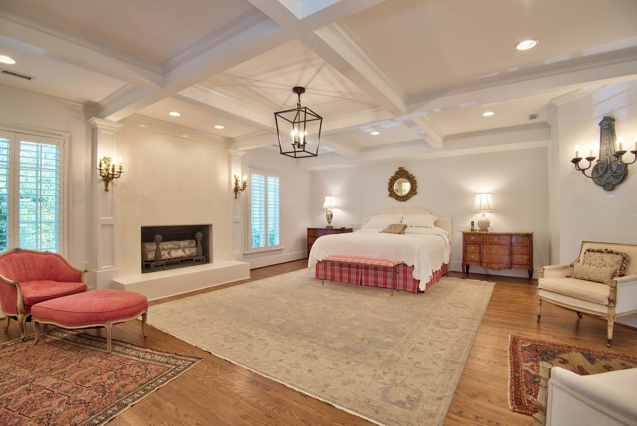 3114 Devon Road Durham, NC 27707 - Photo 17 of 25 a spacious bedroom with a bed a couch and chandelier
