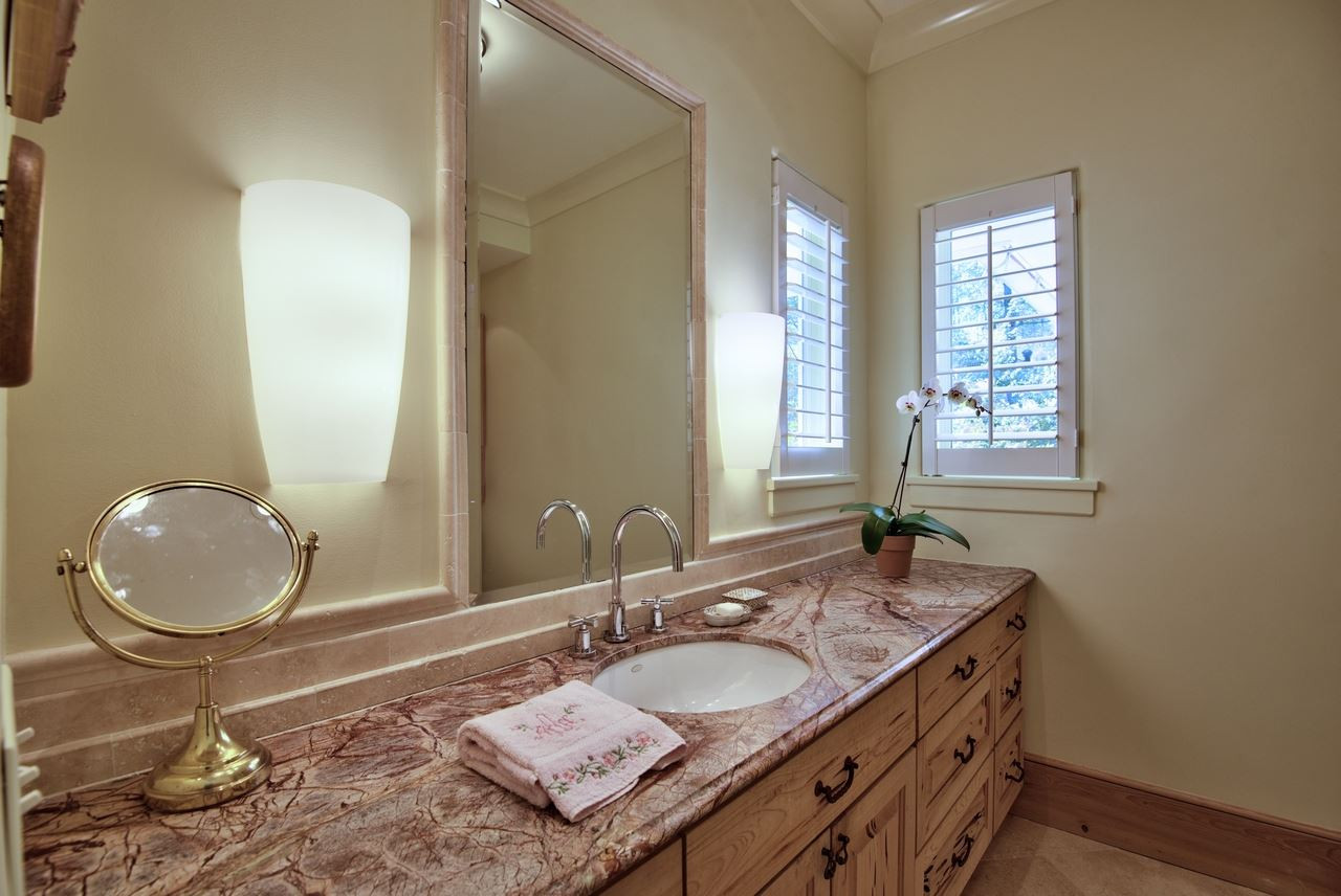 3114 Devon Road Durham, NC 27707 - Photo 24 of 25 a bathroom with a granite countertop sink and a mirror