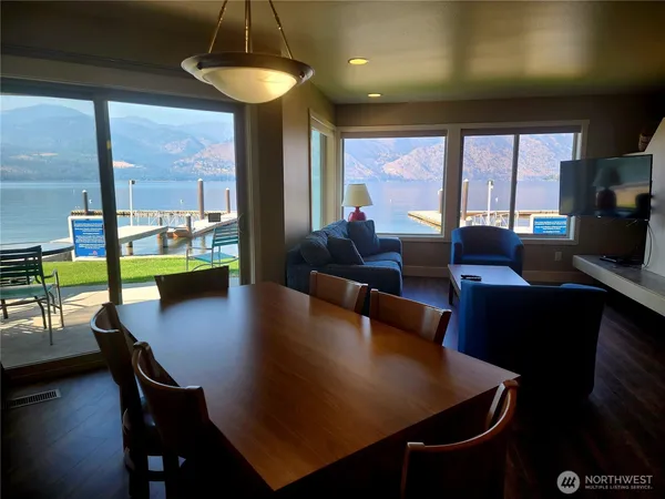 a living room with dining table furniture and a large window