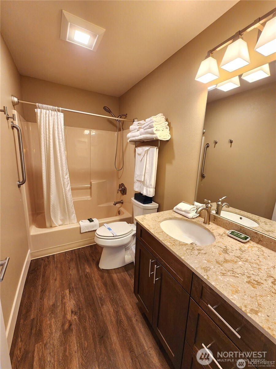 1 Lakeside 714-o Manson, WA 98831 - Photo 12 of 38 a bathroom with a granite countertop sink toilet and shower