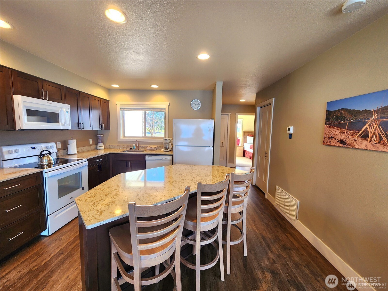 1 Lakeside 714-o Manson, WA 98831 - Photo 9 of 35 a kitchen with a dining table chairs and refrigerator