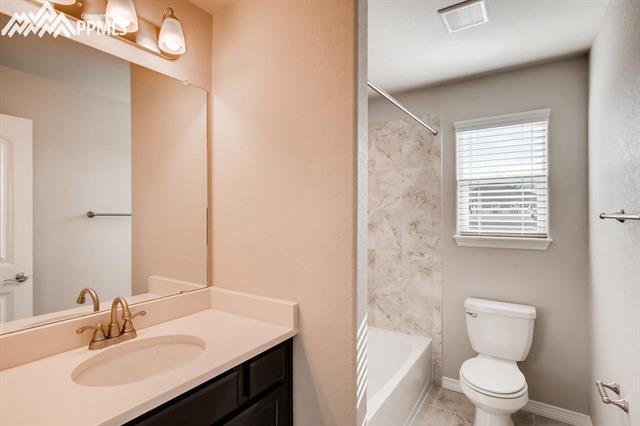 6118 Jorie Road Colorado Springs, CO 80927 - Photo 10 of 11 Secondary bath upstairs. the bathroom in the basement is outfit with the same counters floor tile and wall tile
