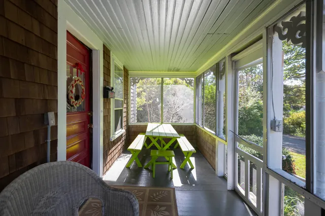 a living room filled with furniture and a large window