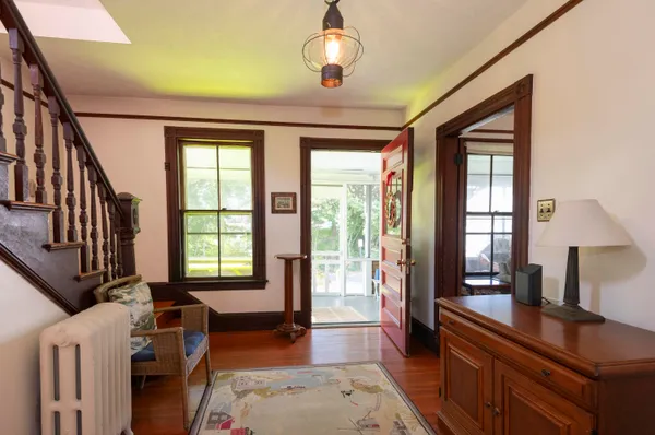 a view of a livingroom with furniture hardwood floor and a ceiling fan