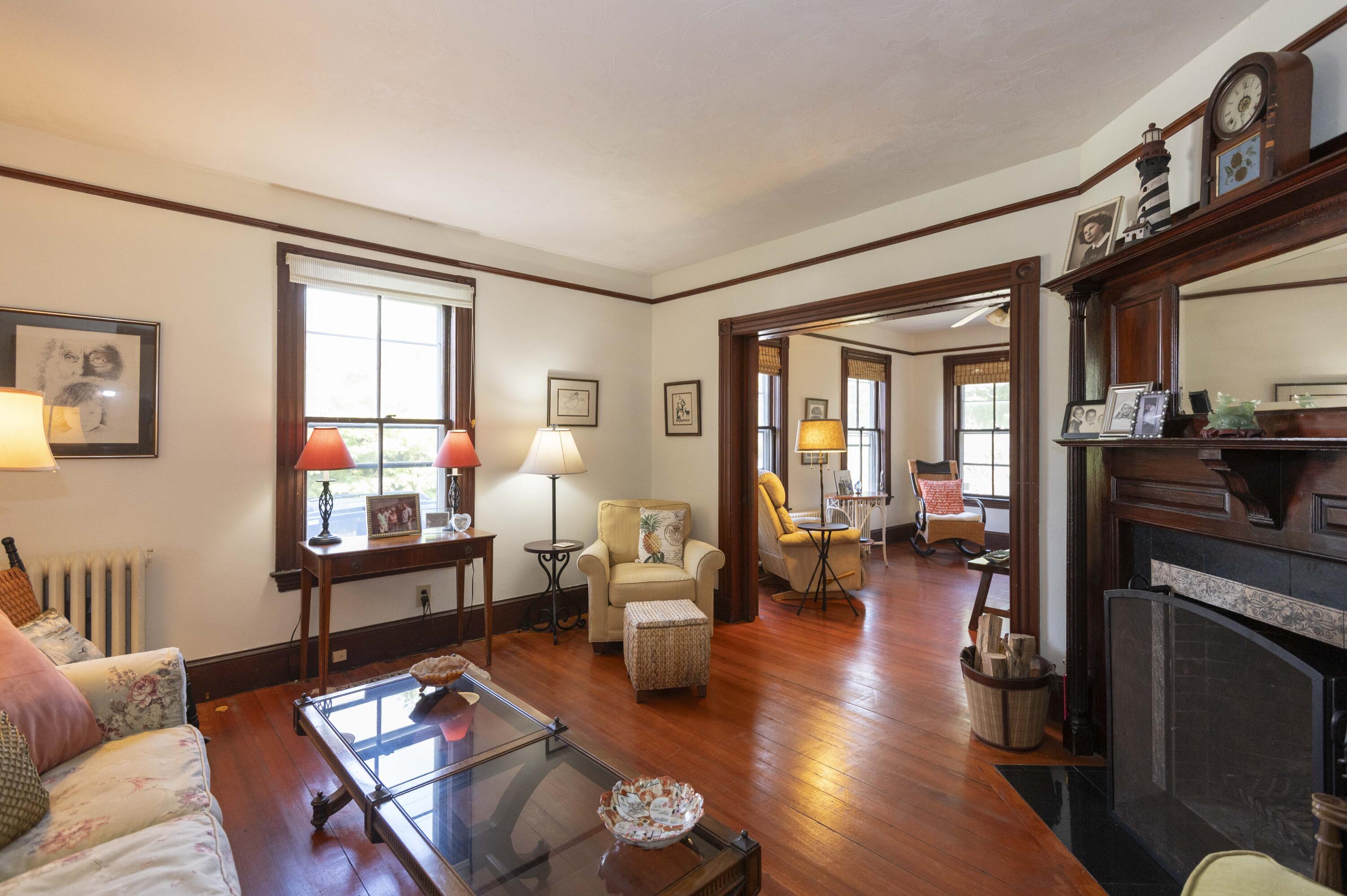 15 Bowditch Road Falmouth, MA 02543 - Photo 4 of 16 a living room with furniture a wooden floor and a large window