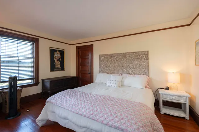 a bedroom with a large bed and a window