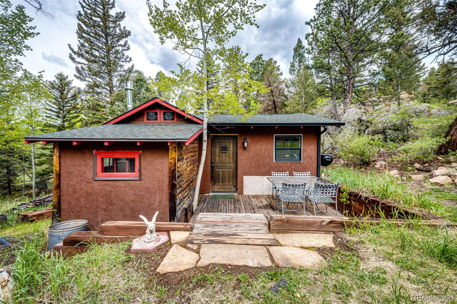12346 Bear Haven Road Conifer, CO 80433 - Photo 29 of 47 a front view of a house with garden
