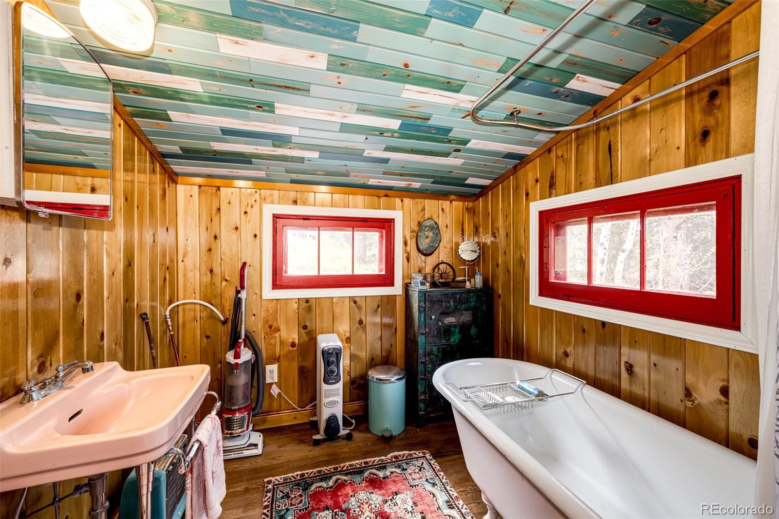 12346 Bear Haven Road Conifer, CO 80433 - Photo 33 of 47 a bathroom with a tub sink and mirror