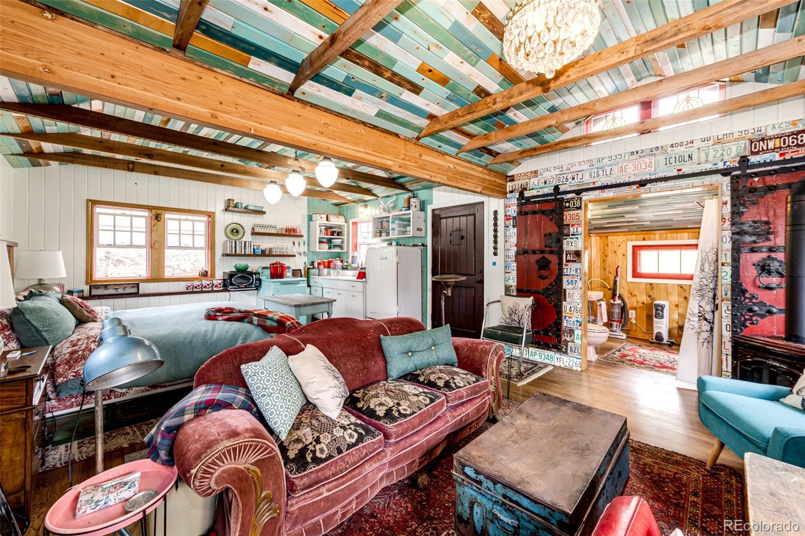 12346 Bear Haven Road Conifer, CO 80433 - Photo 34 of 47 a outdoor living space with furniture and a fireplace