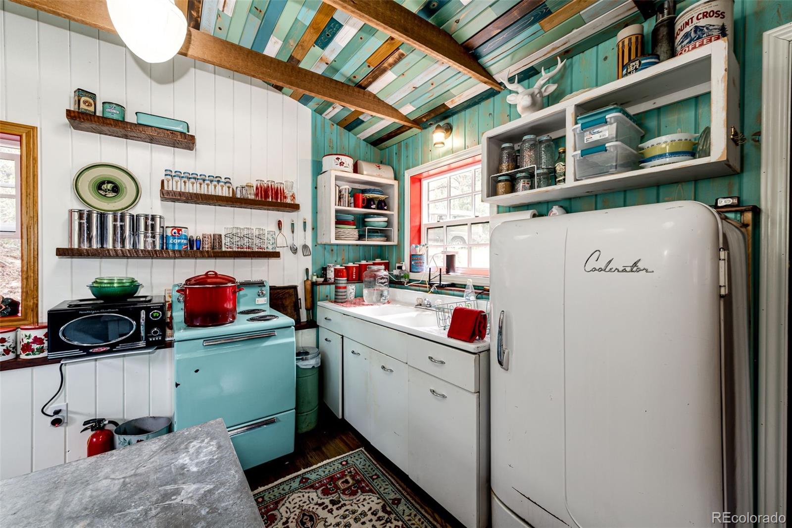 12346 Bear Haven Road Conifer, CO 80433 - Photo 36 of 47 a storage room with washer and dryer