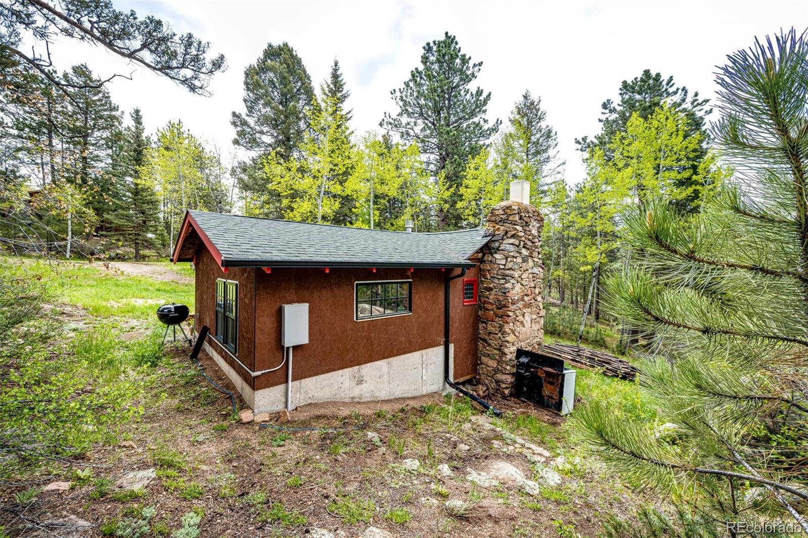 12346 Bear Haven Road Conifer, CO 80433 - Photo 42 of 47 a view of a house with a yard
