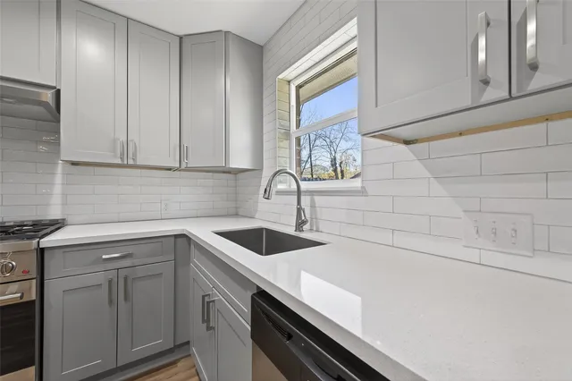 a kitchen with a sink and cabinets