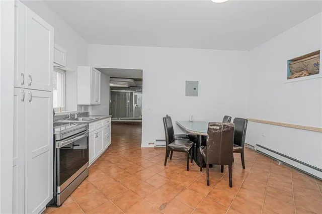 a kitchen with granite countertop cabinets stainless steel appliances and dining table