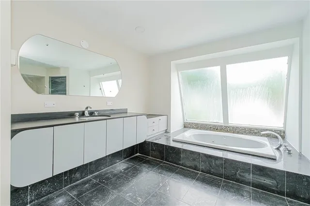 a bathroom with a bathtub and a sink