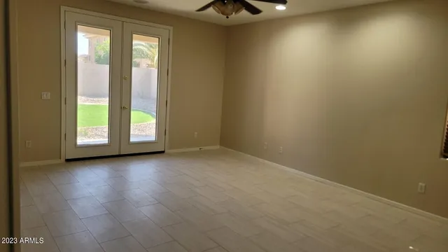 an empty room with windows and entrance