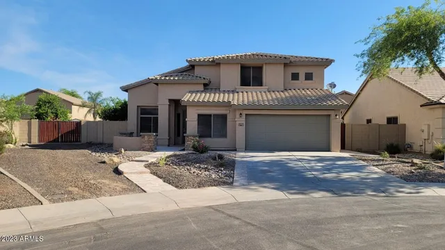 a front view of a house with garage and parking
