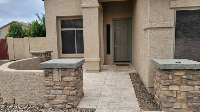 a view of a house with backyard and sitting area