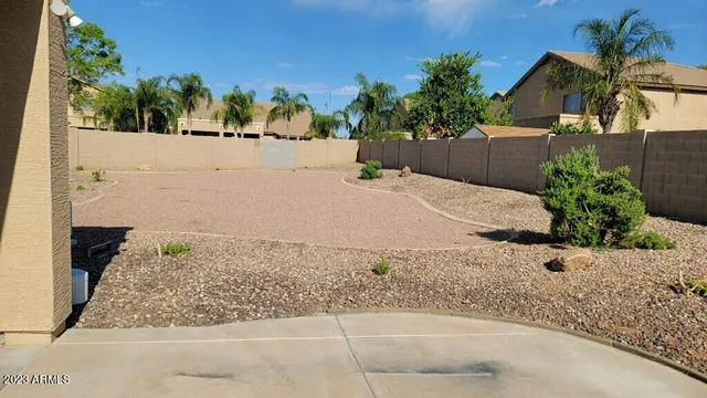 a backyard of a house with barbeque oven
