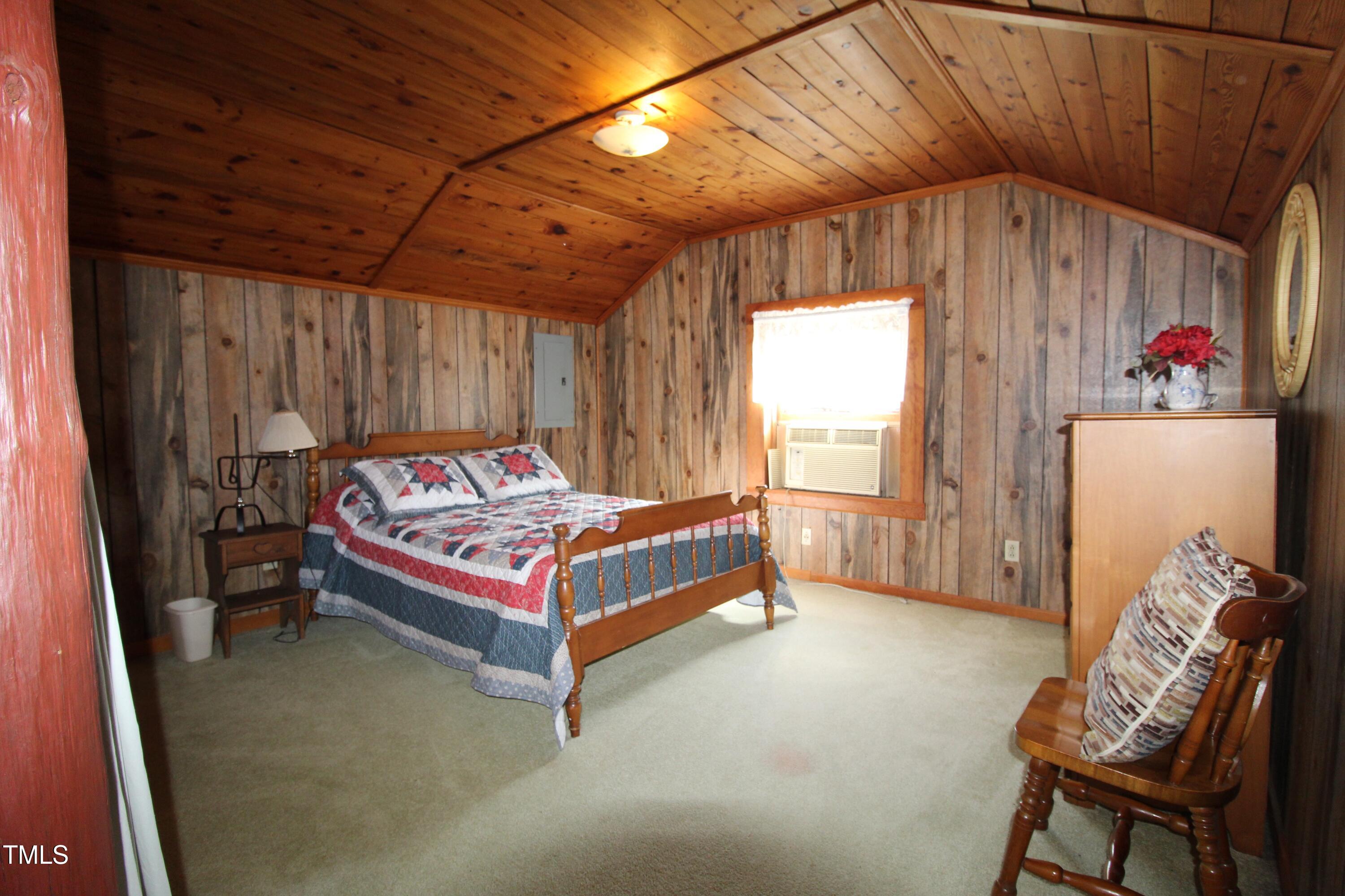 455 Hogan Farm Road Seagrove, NC 27341 - Photo 56 of 70 a bedroom with a bed and a chair