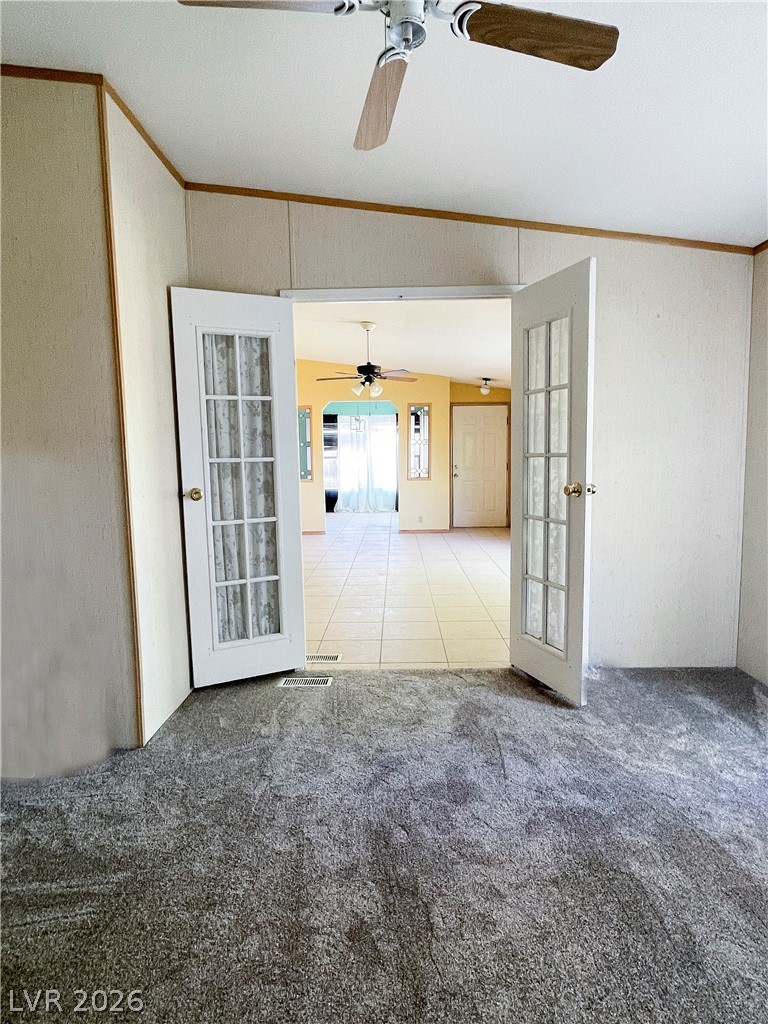 75 West Obsidian Avenue Sandy Valley, NV 89019 - Photo 17 of 23 This versatile interior space connects seamlessly with french doors, offering both comfort and functional design.