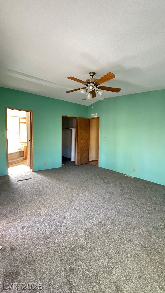 75 West Obsidian Avenue Sandy Valley, NV 89019 - Photo 23 of 23 This spacious bedroom offers ample space and direct access to a private bathroom.