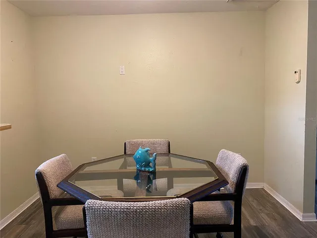 a dining room with furniture and wooden floor