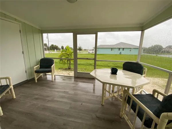 a living room with furniture and a floor to ceiling window