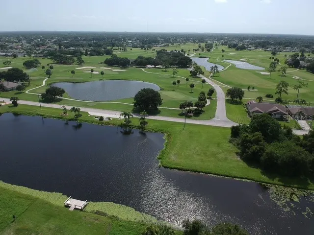 an aerial view of a golf course with parking space
