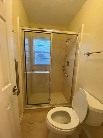 a bathroom with a toilet and a shower