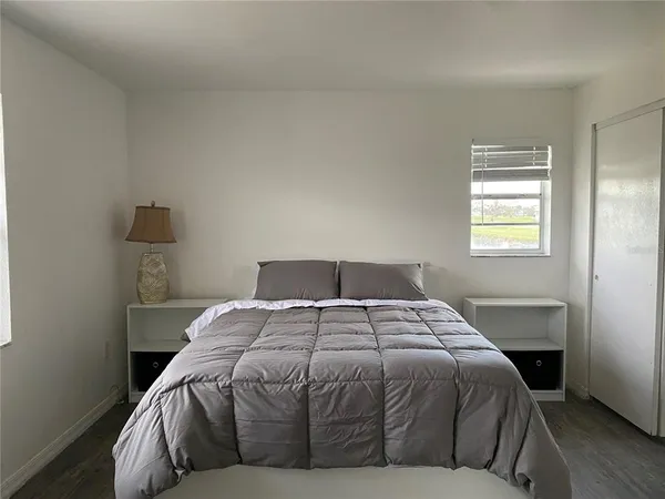 a bedroom with a bed and window