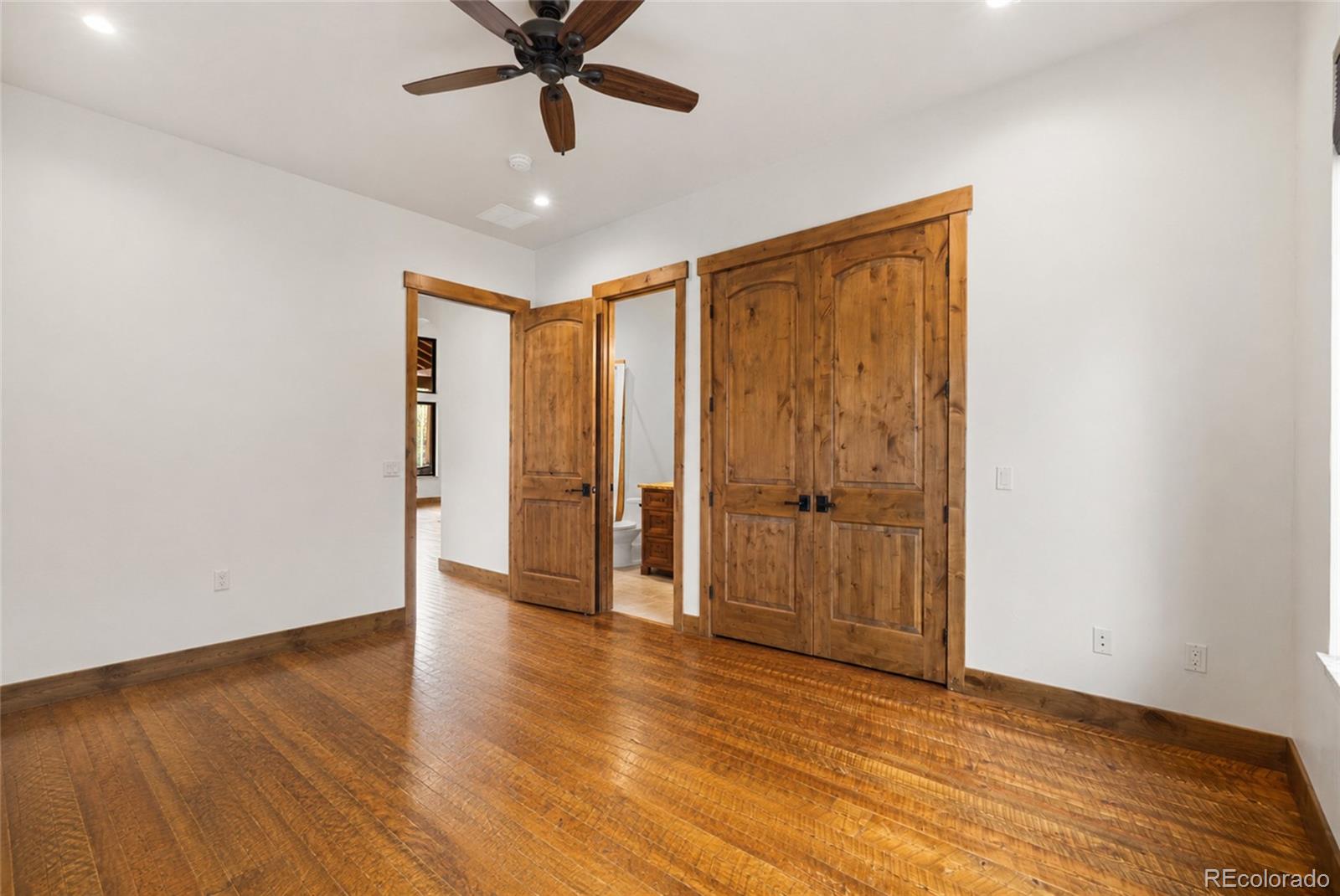 280 Double Tree Road Bailey, CO 80421 - Photo 22 of 43 a view of an empty room with wooden floor