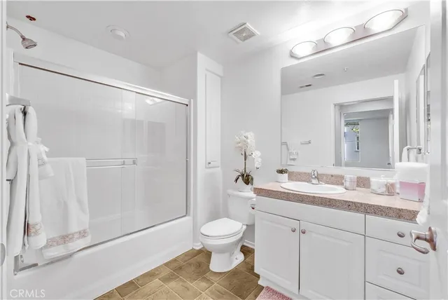 a kitchen with granite countertop white cabinets and a sink