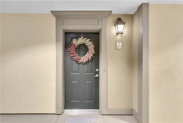 a view of entryway with white walls and cabinets