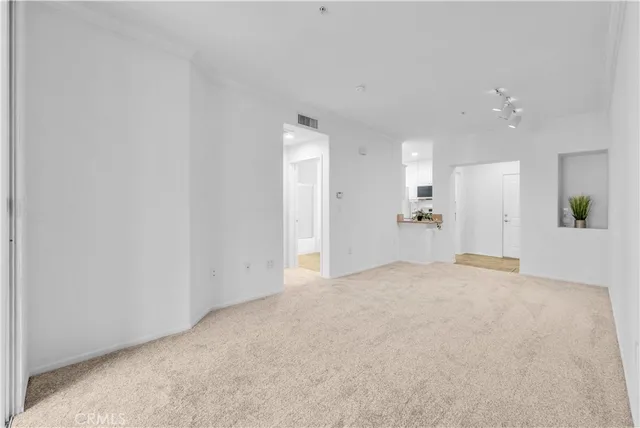a living room with furniture kitchen view and a refrigerator