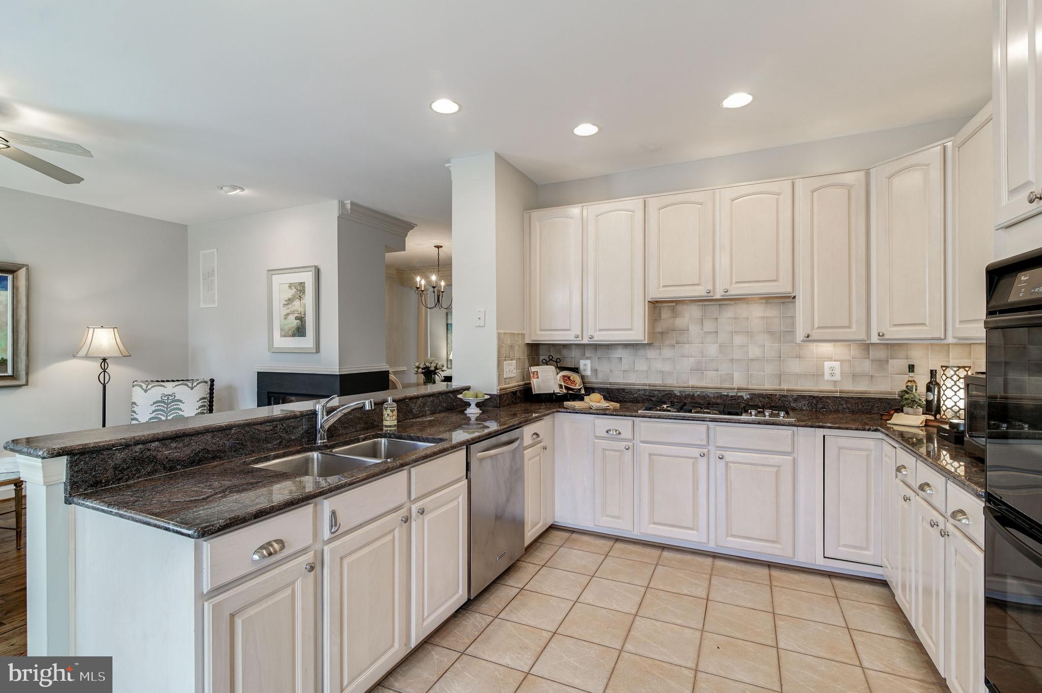 150 Rees Place Falls Church, VA 22046 - Photo 12 of 27 Breakfast bar and ceramic tile backsplash in Kitch