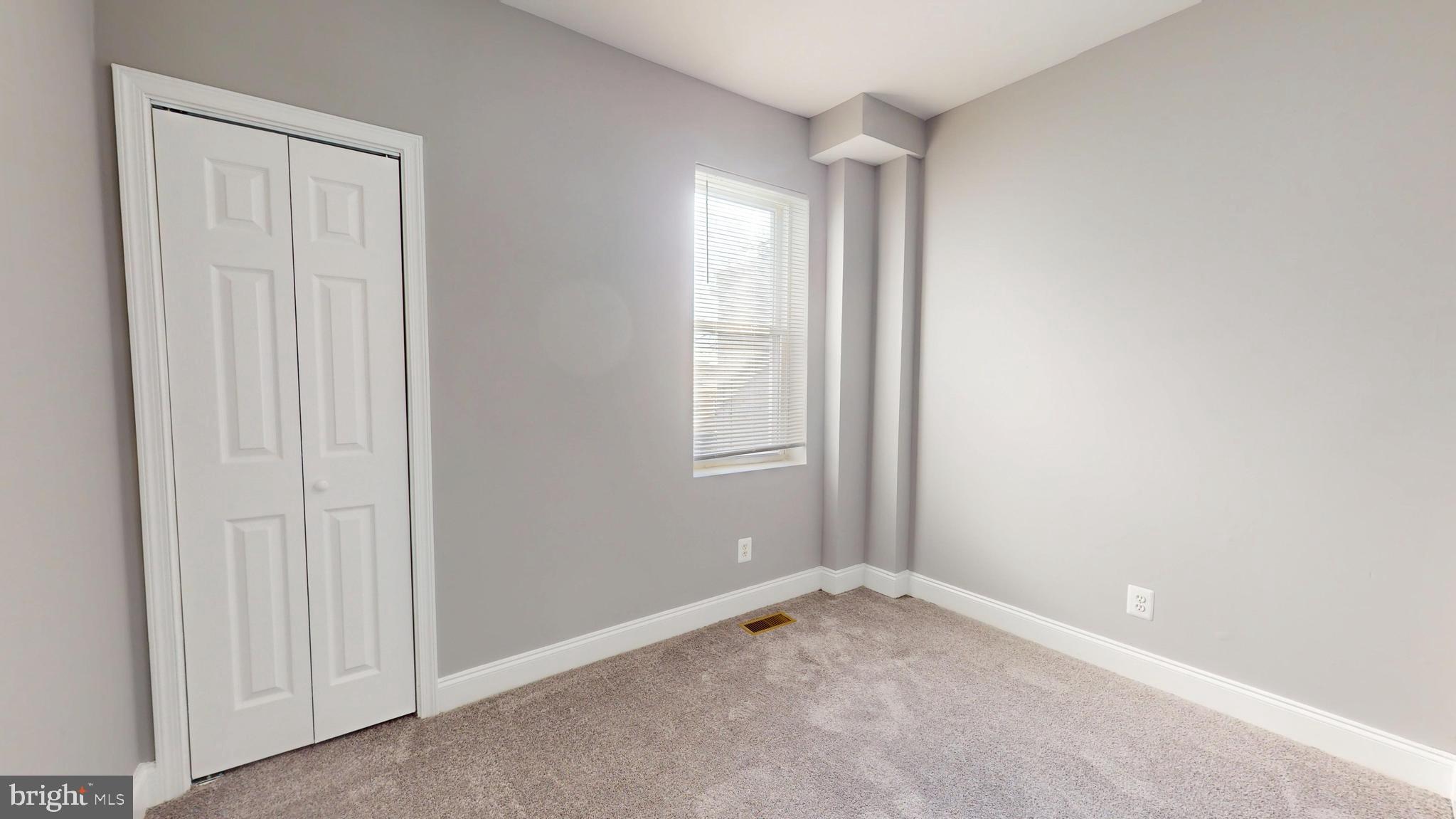 2615 East Chase Street Baltimore, MD 21213 - Photo 12 of 17 an empty room with windows