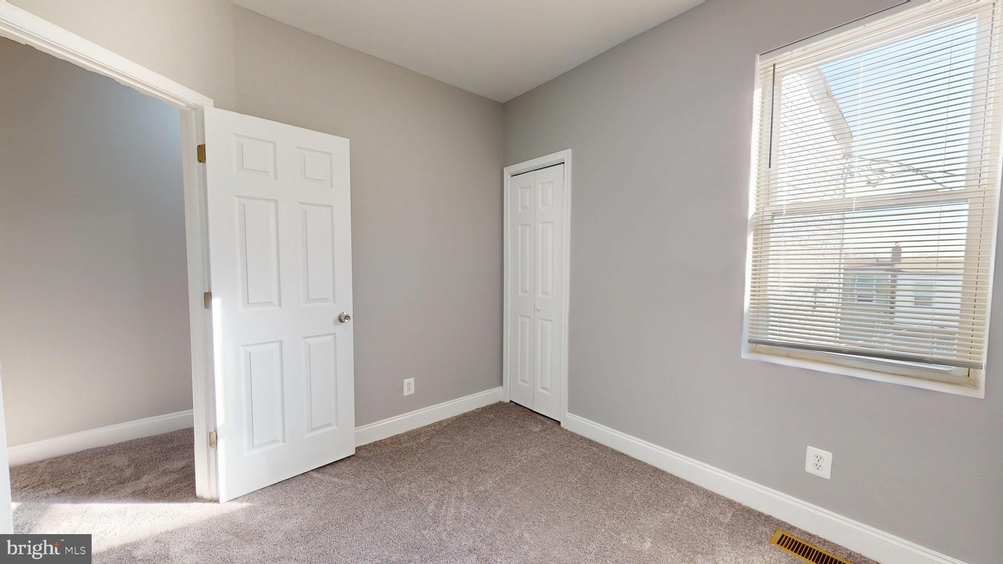 2615 East Chase Street Baltimore, MD 21213 - Photo 13 of 17 an empty room with windows