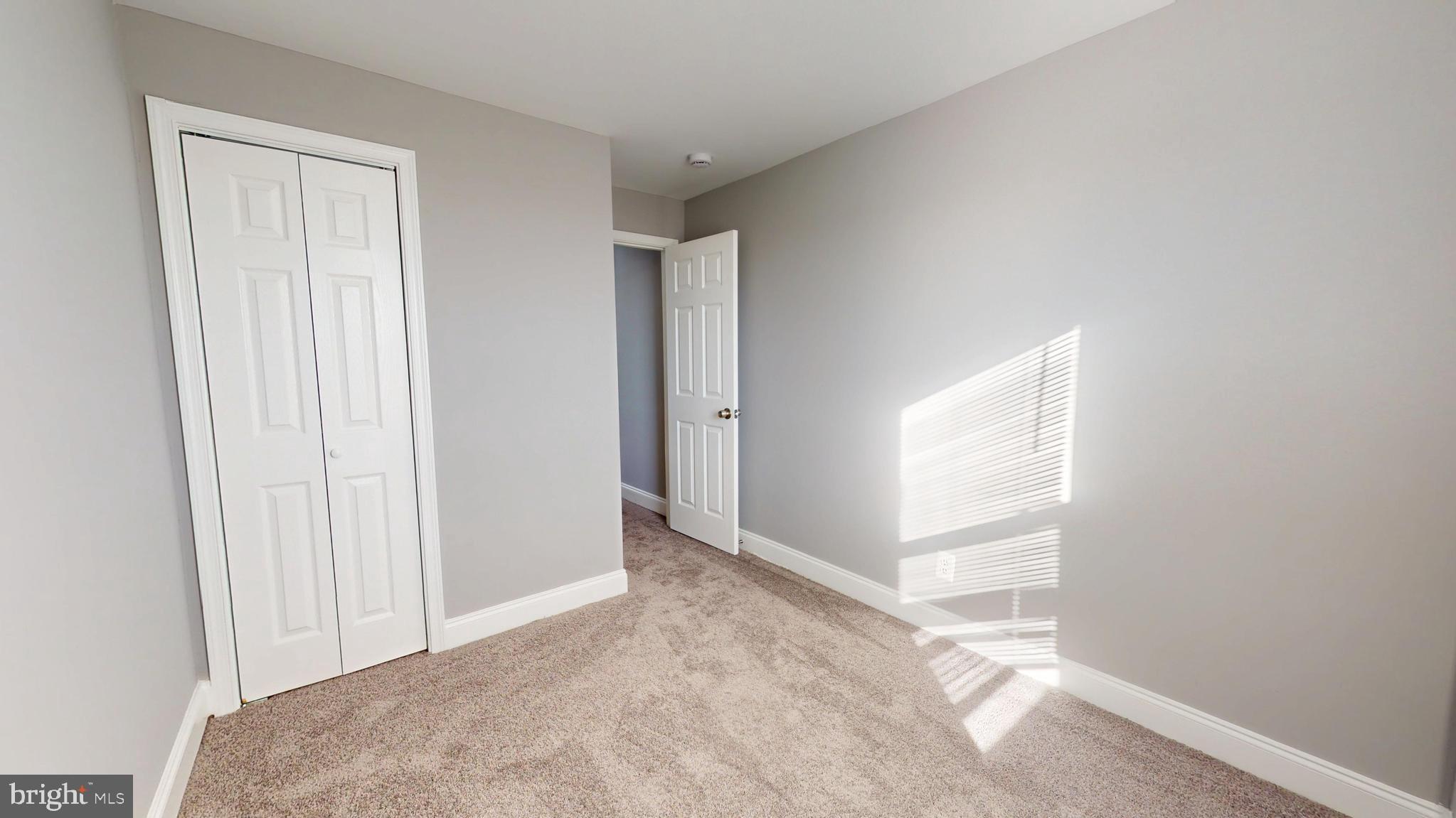 2615 East Chase Street Baltimore, MD 21213 - Photo 15 of 17 an empty room with windows
