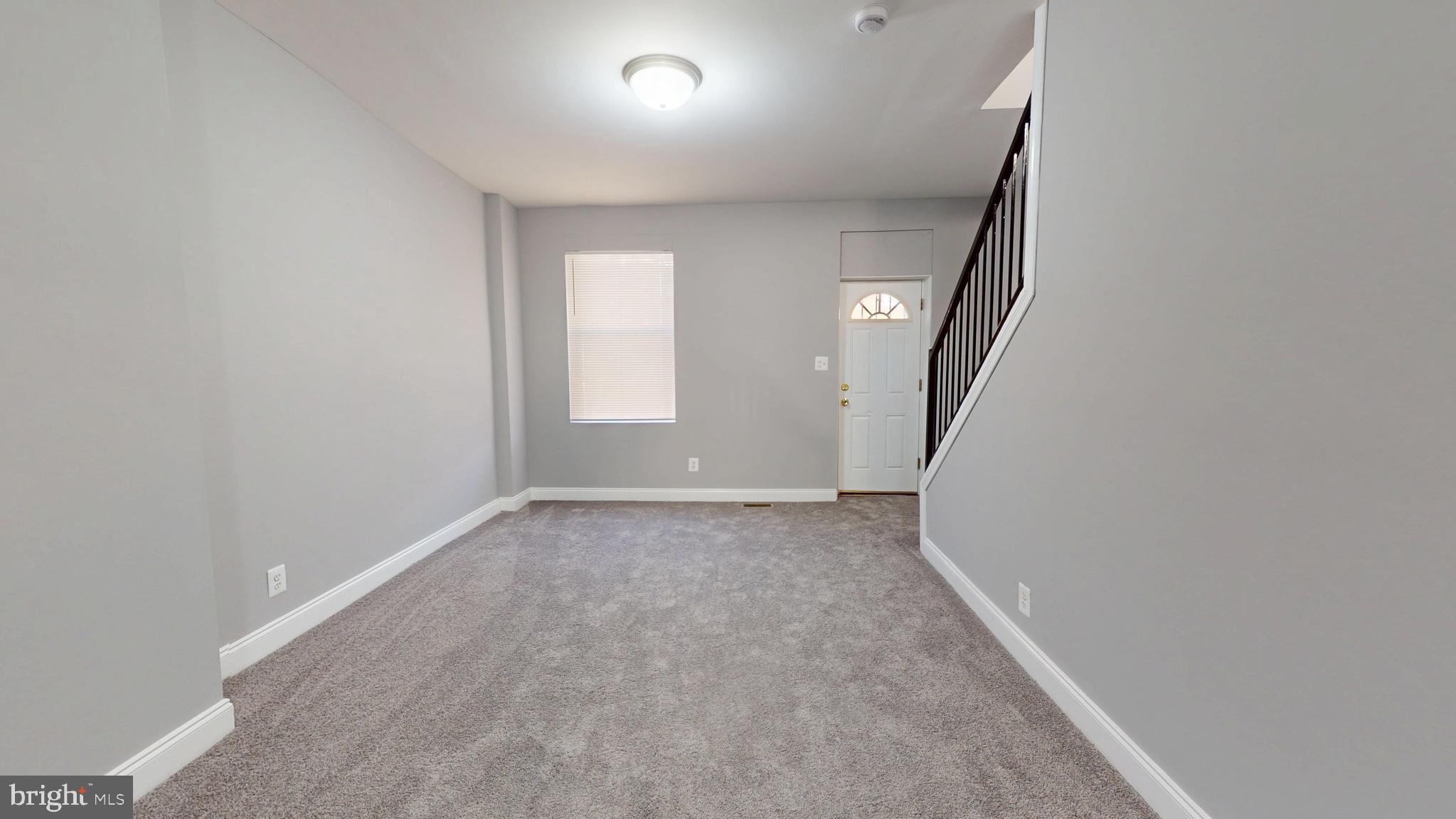 2615 East Chase Street Baltimore, MD 21213 - Photo 4 of 17 an empty room with windows