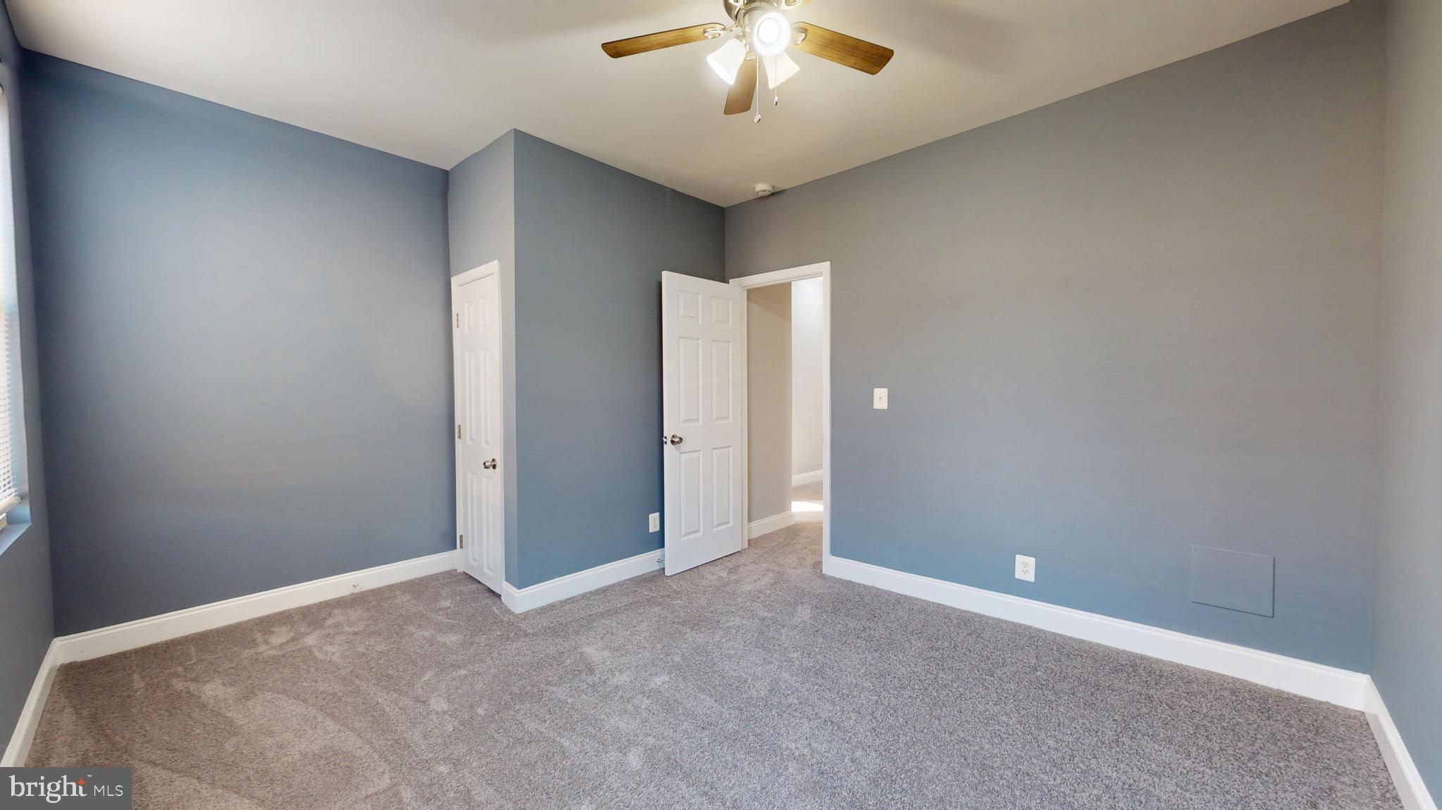 2615 East Chase Street Baltimore, MD 21213 - Photo 10 of 17 a view of an empty room with a chandelier fan