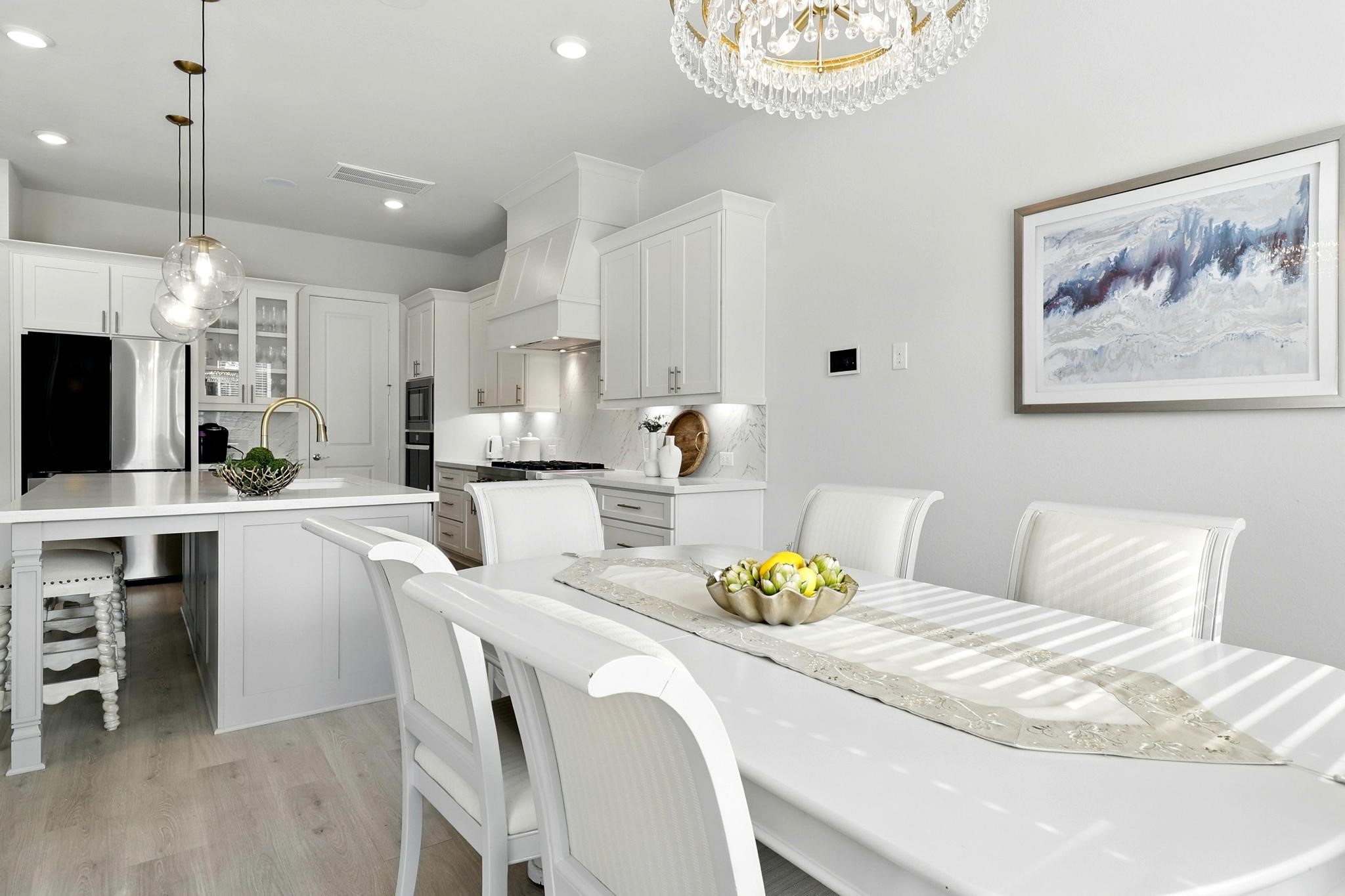 26923 Arethusa Court Spring, TX 77389 - Photo 12 of 44 The dining area features a stylish chandelier and contemporary artwork, creating a welcoming atmosphere.