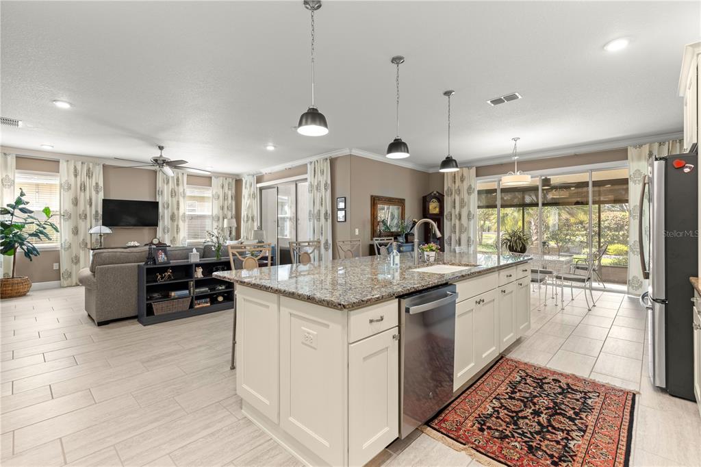 9099 Southwest 89th Loop Ocala, FL 34481 - Photo 16 of 66 a kitchen with stainless steel appliances granite countertop a sink and a refrigerator