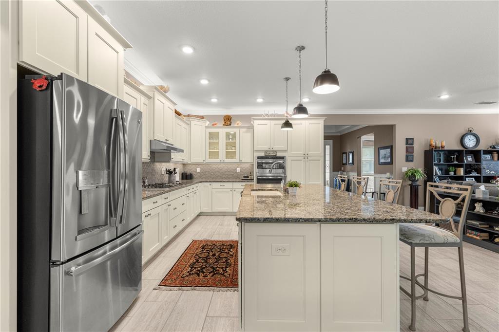 9099 Southwest 89th Loop Ocala, FL 34481 - Photo 17 of 66 a kitchen with stainless steel appliances granite countertop a refrigerator a sink and a stove