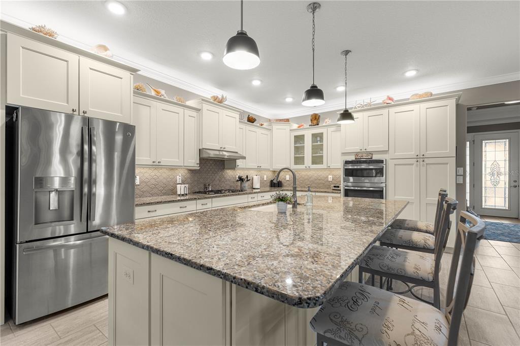 9099 Southwest 89th Loop Ocala, FL 34481 - Photo 19 of 66 a kitchen with stainless steel appliances granite countertop a refrigerator a oven and a sink