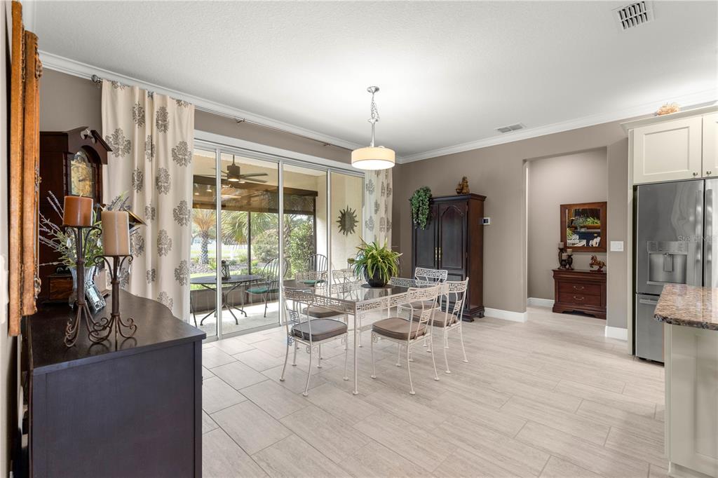 9099 Southwest 89th Loop Ocala, FL 34481 - Photo 20 of 66 a living room with furniture a chandelier and a large window