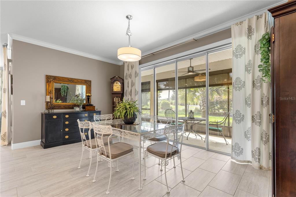 9099 Southwest 89th Loop Ocala, FL 34481 - Photo 22 of 66 a view of a dining room with furniture large windows and wooden floor