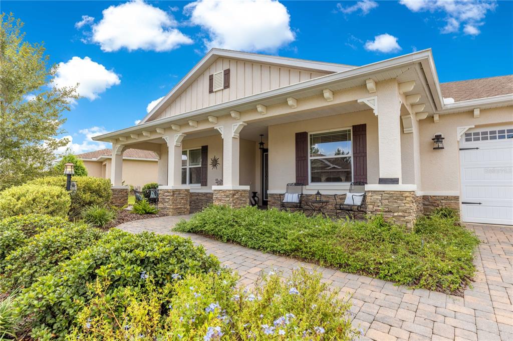9099 Southwest 89th Loop Ocala, FL 34481 - Photo 3 of 66 a front view of a house with garden